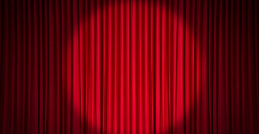 Une poursuite éclaire un rideau rouge de théâtre